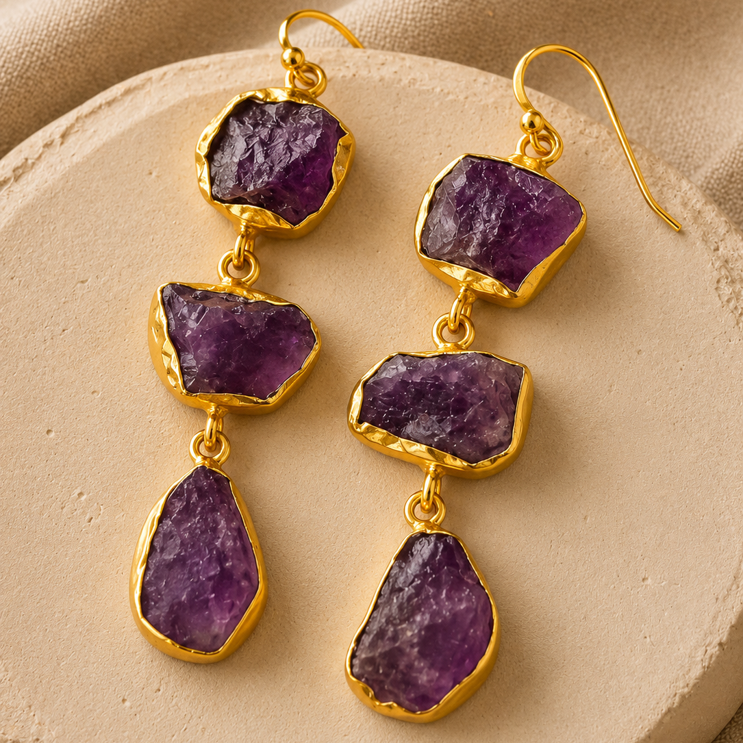Veda raw Amethyst cascade earrings featuring three natural uncut purple gemstones in 18K gold-plated brass by House of AAKAASHI