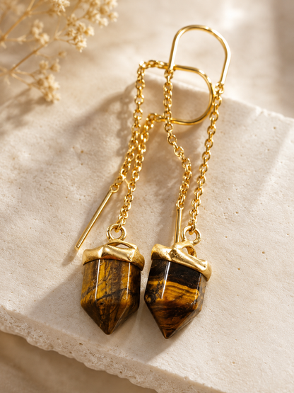 Golden Tiger Eye Sui Dhaga earrings featuring natural faceted Tiger Eye crystal point pendants in an 18K gold plated brass threader design by House of AAKAASHI