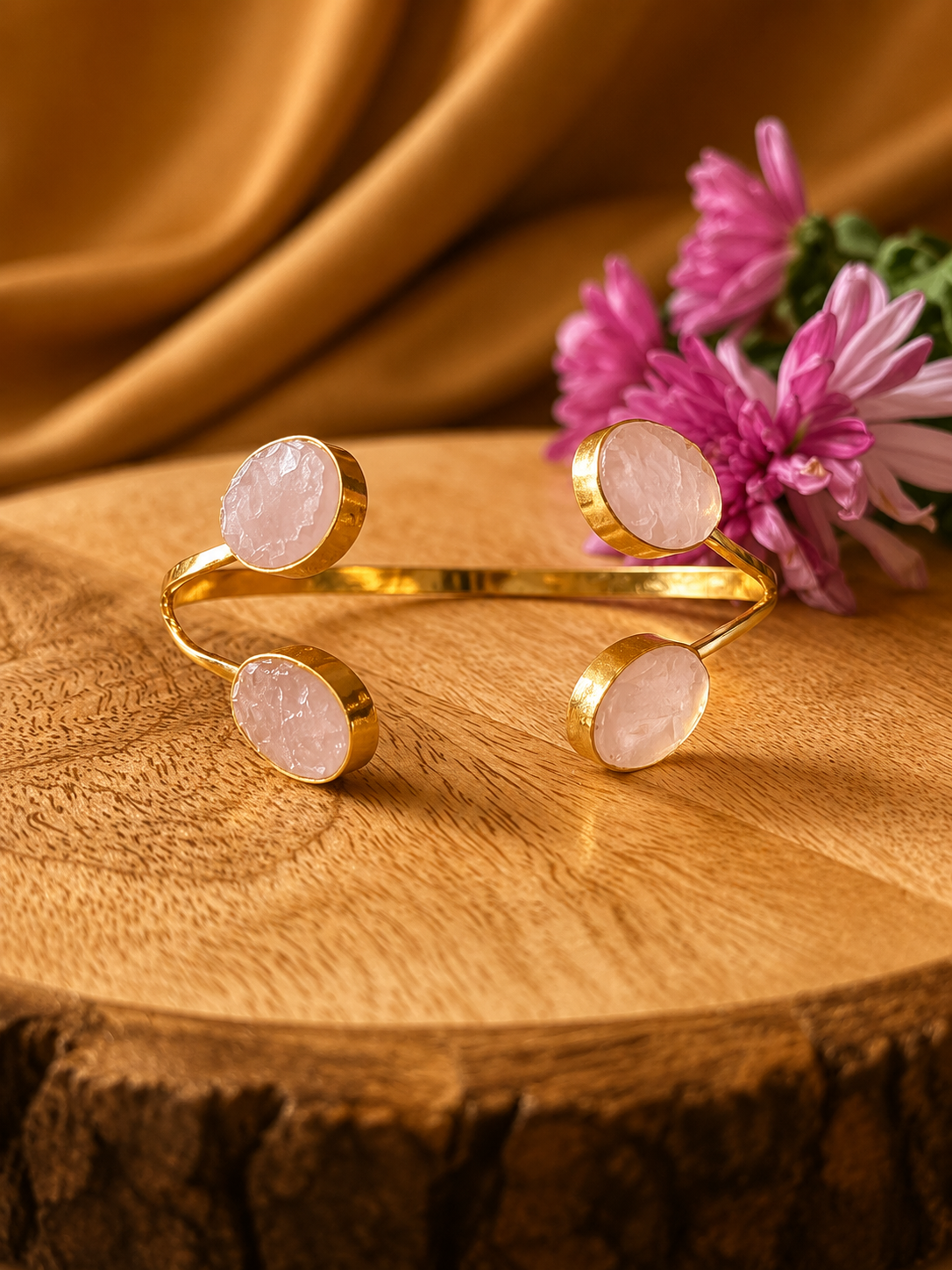Gulabi Rose Quartz adjustable cuff bracelet with four polished pink cabochon gemstones in 18K gold-plated brass by House of AAKAASHI